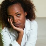 sad-african-american-woman-depression-looking-camera-indoor-home-93821370